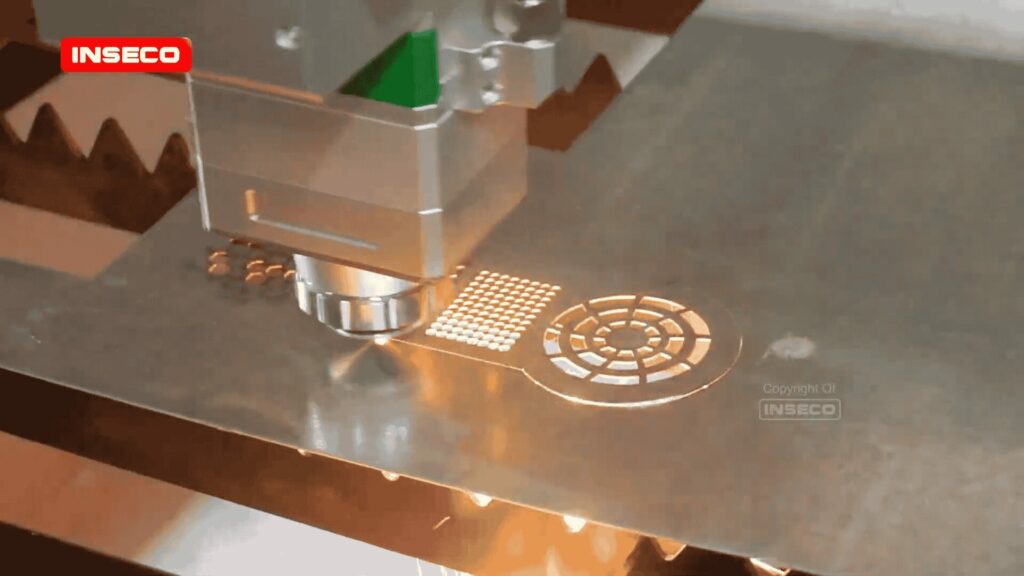 Detail kepala laser Raytools BM110 dalam proses pemotongan plat logam CNC.